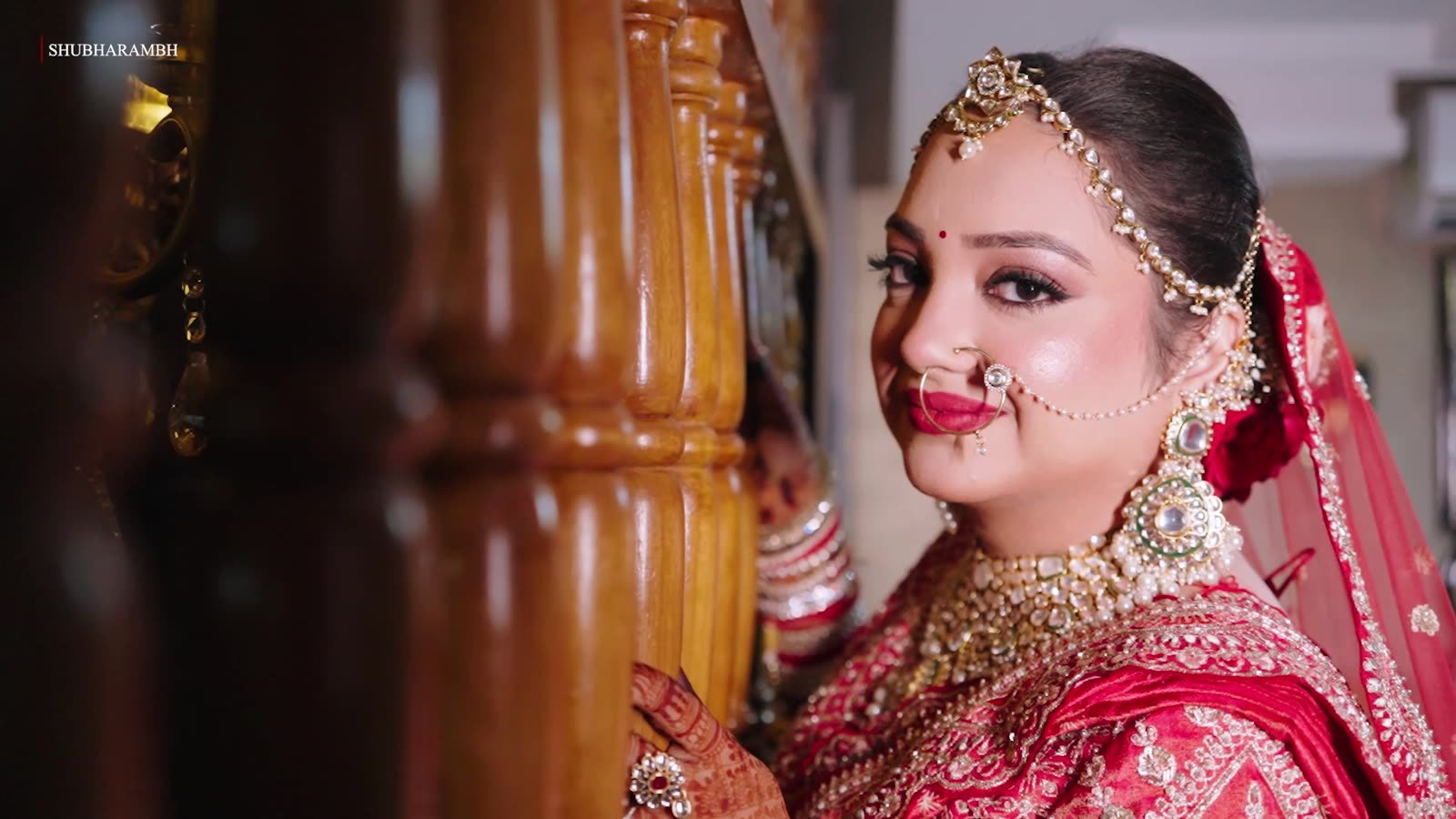 Bride glancing past a carved pillar
